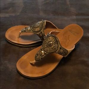Women’s Dansko sandals with embellishments.